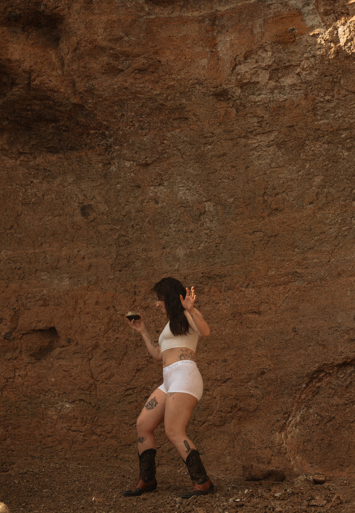 woman runs along the Moab, Utah sandstone on a hot, sunny day