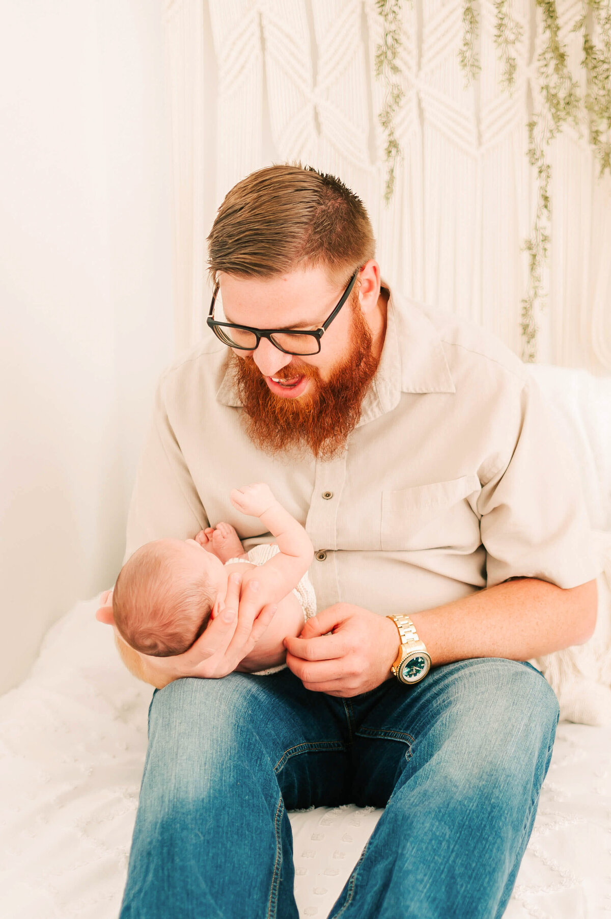 dad smiling at baby boy in Branson MO newborn photography studio