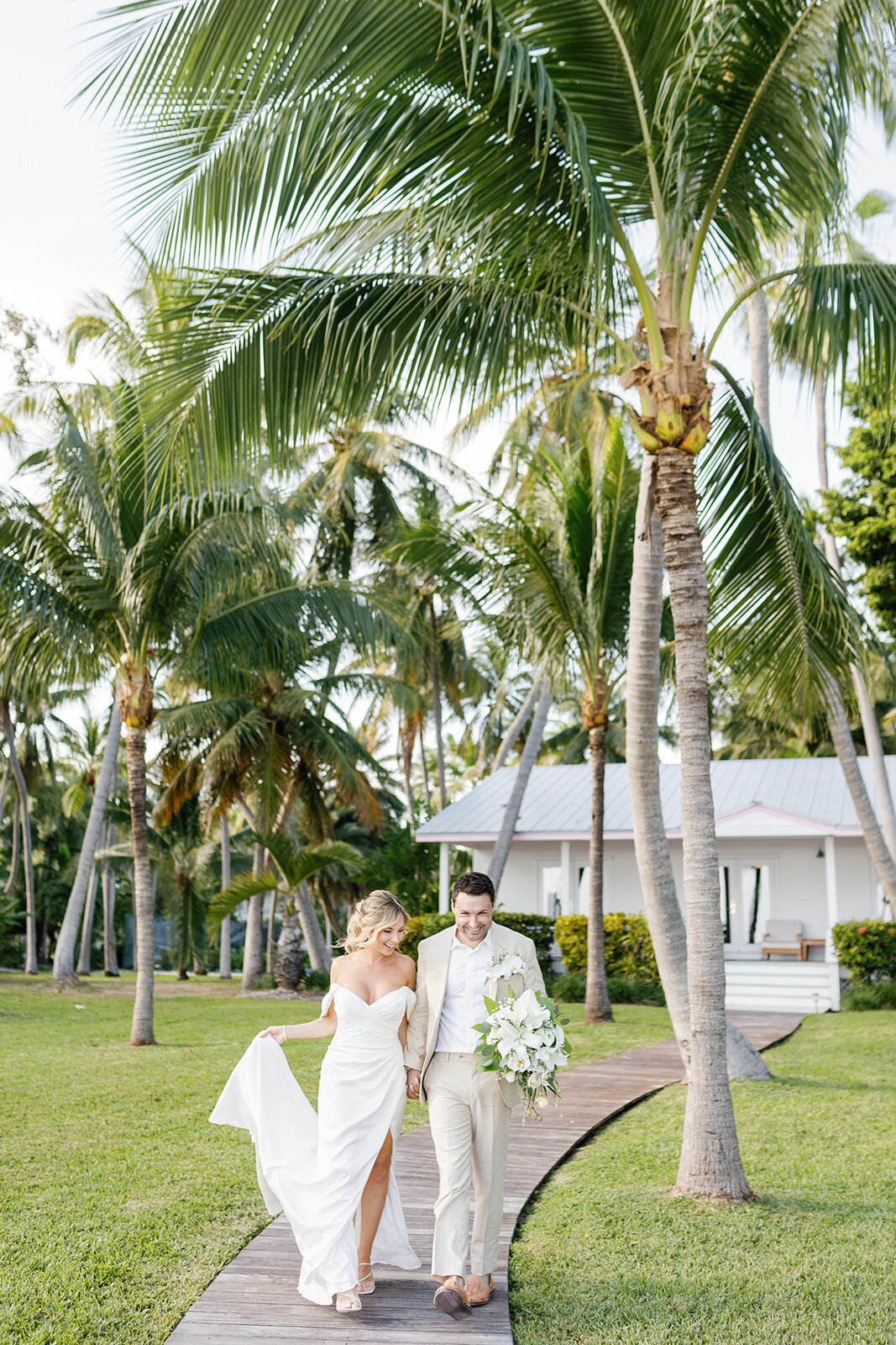 The newlyweds walk hand in hand, taking in the beauty of their intimate micro wedding in Islamorada, Florida.