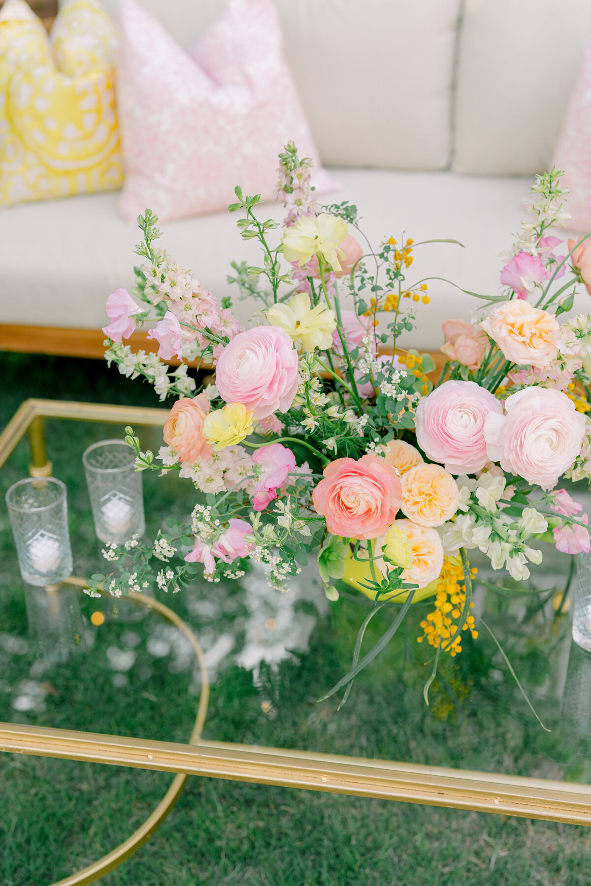 wedding reception couches and furniture with pink and yellow flowers