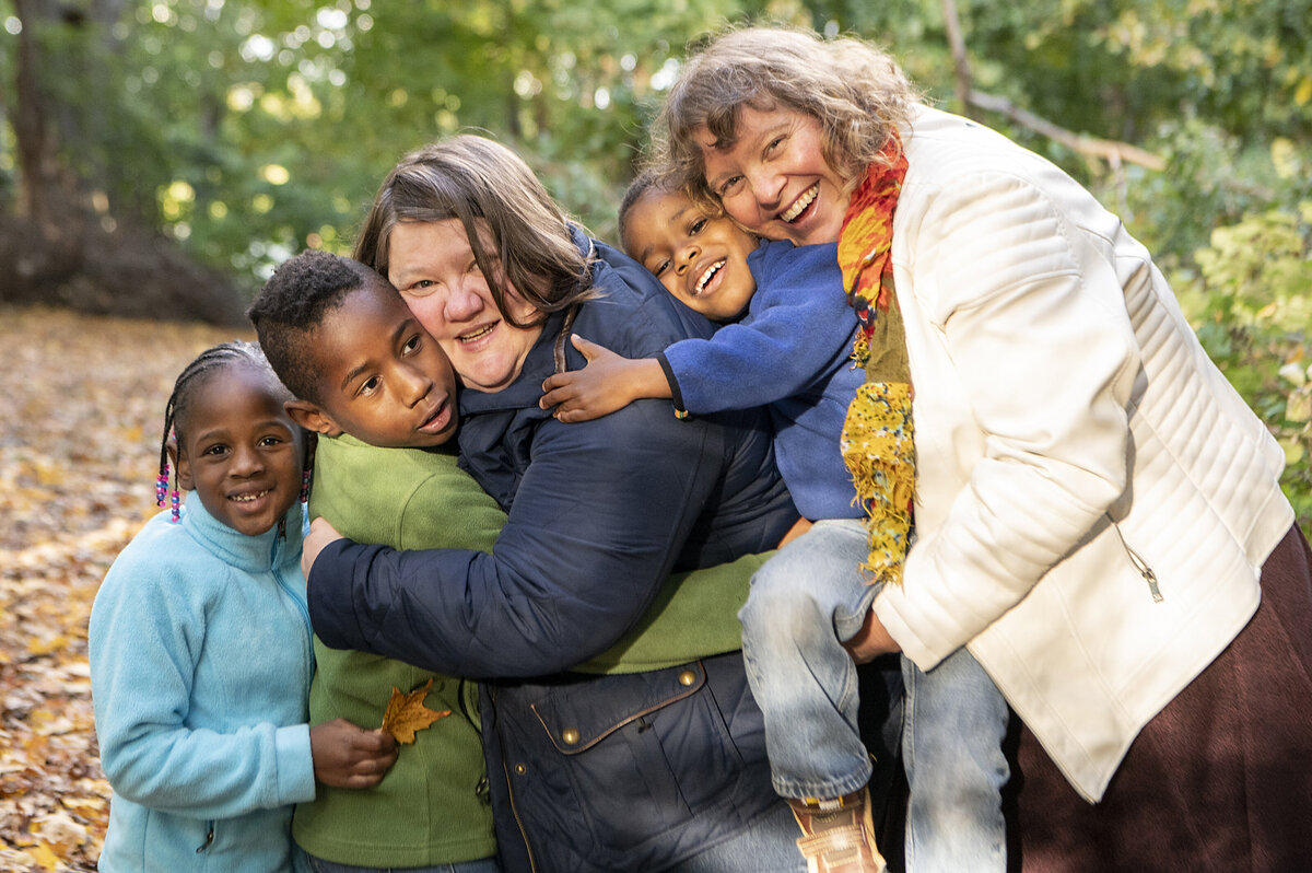 Two moms hug their kids in Westchester, NY. 