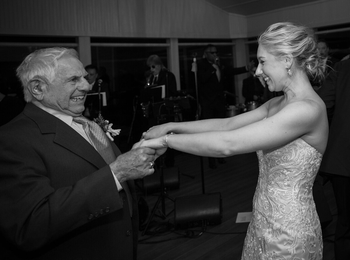 Bride dances with grandfather during wedding reception.