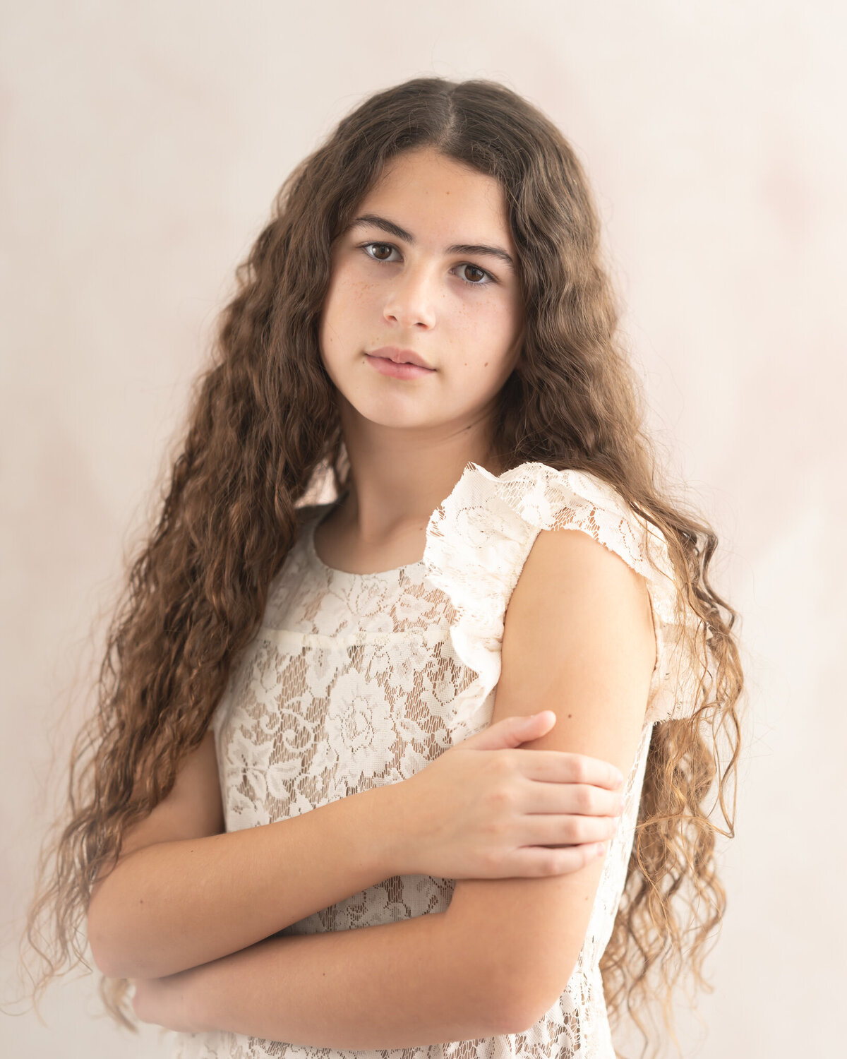 peach and cream colored studio portrait on fine art backdrop