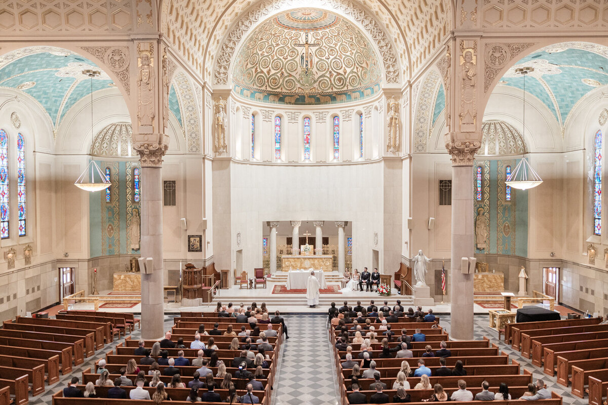 A wide shot of an opulent cathedral with high cielings and grand arches