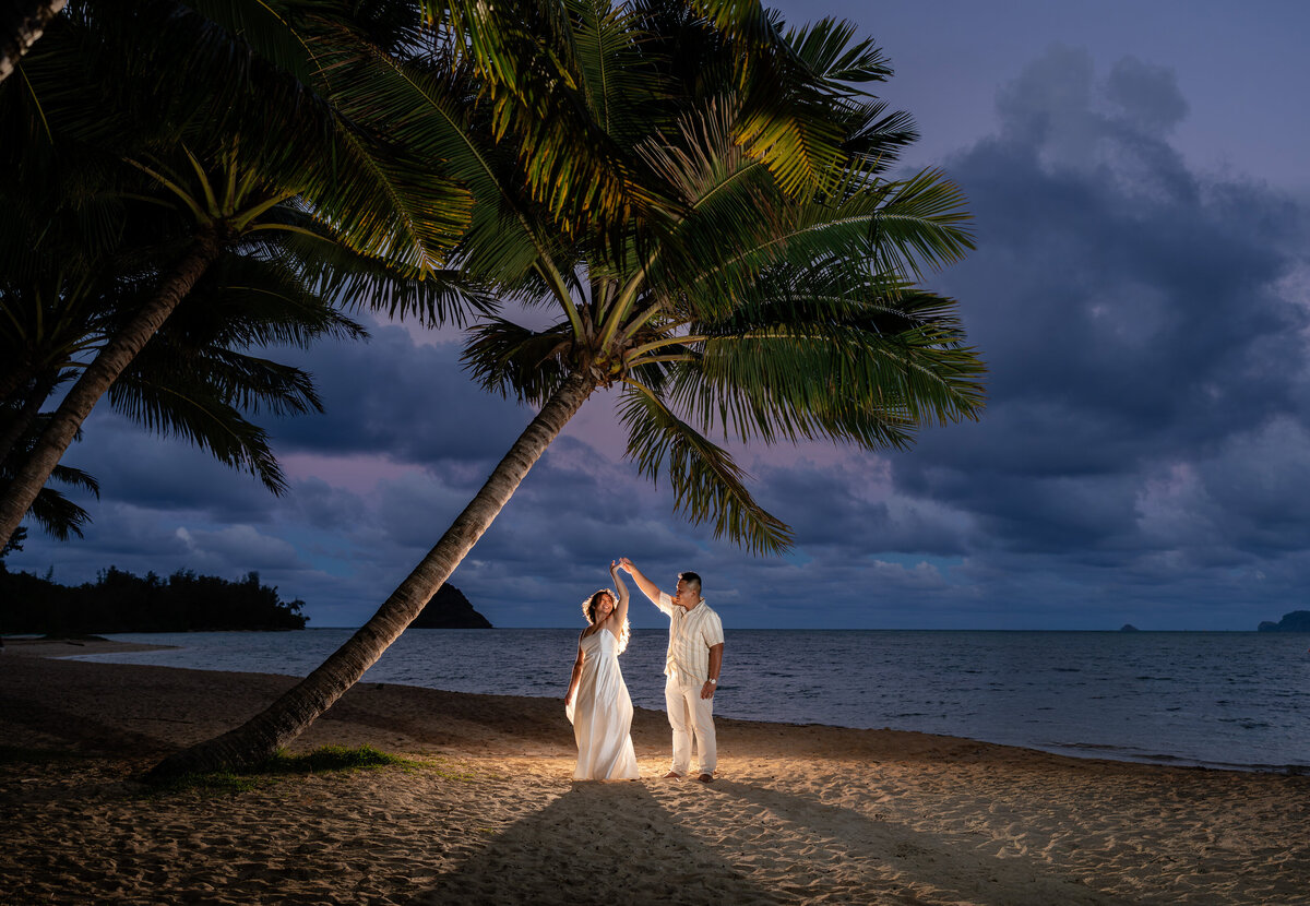 Oahu Hawaii Elopement Adventurous Asian couple at Secret Island Beach during blue hour at night with off camera flash.