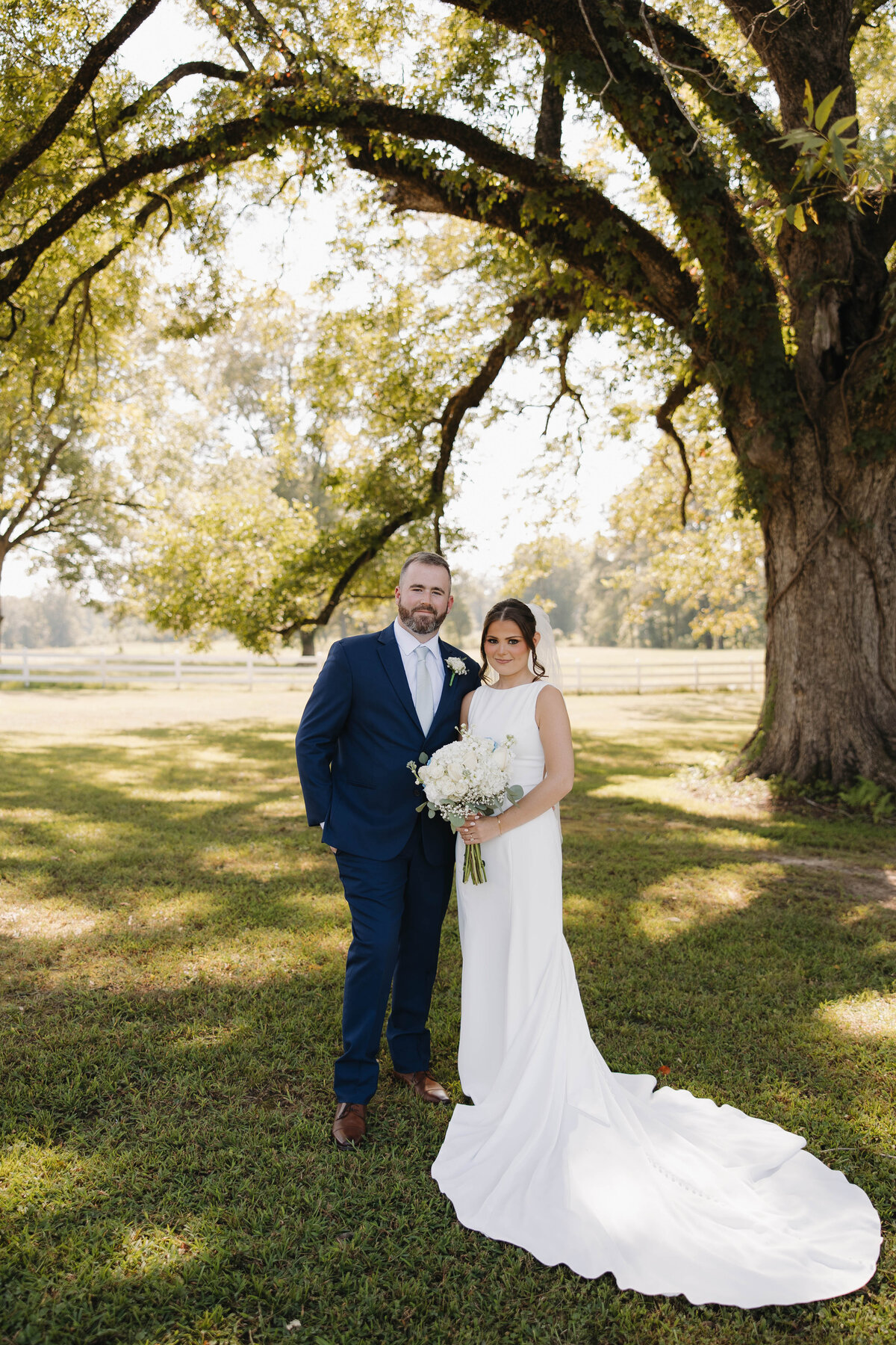 bride and groom portraits under large oak tree at Dodson farms