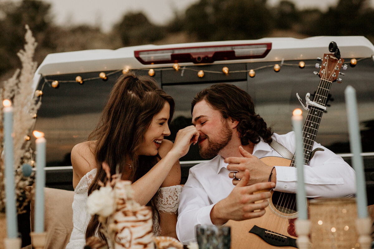 bride and groom cutting cake in their truck bed in New Mexico