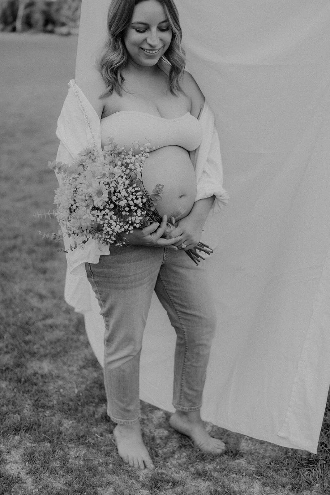 Close up of a pregnant belly with flowers
