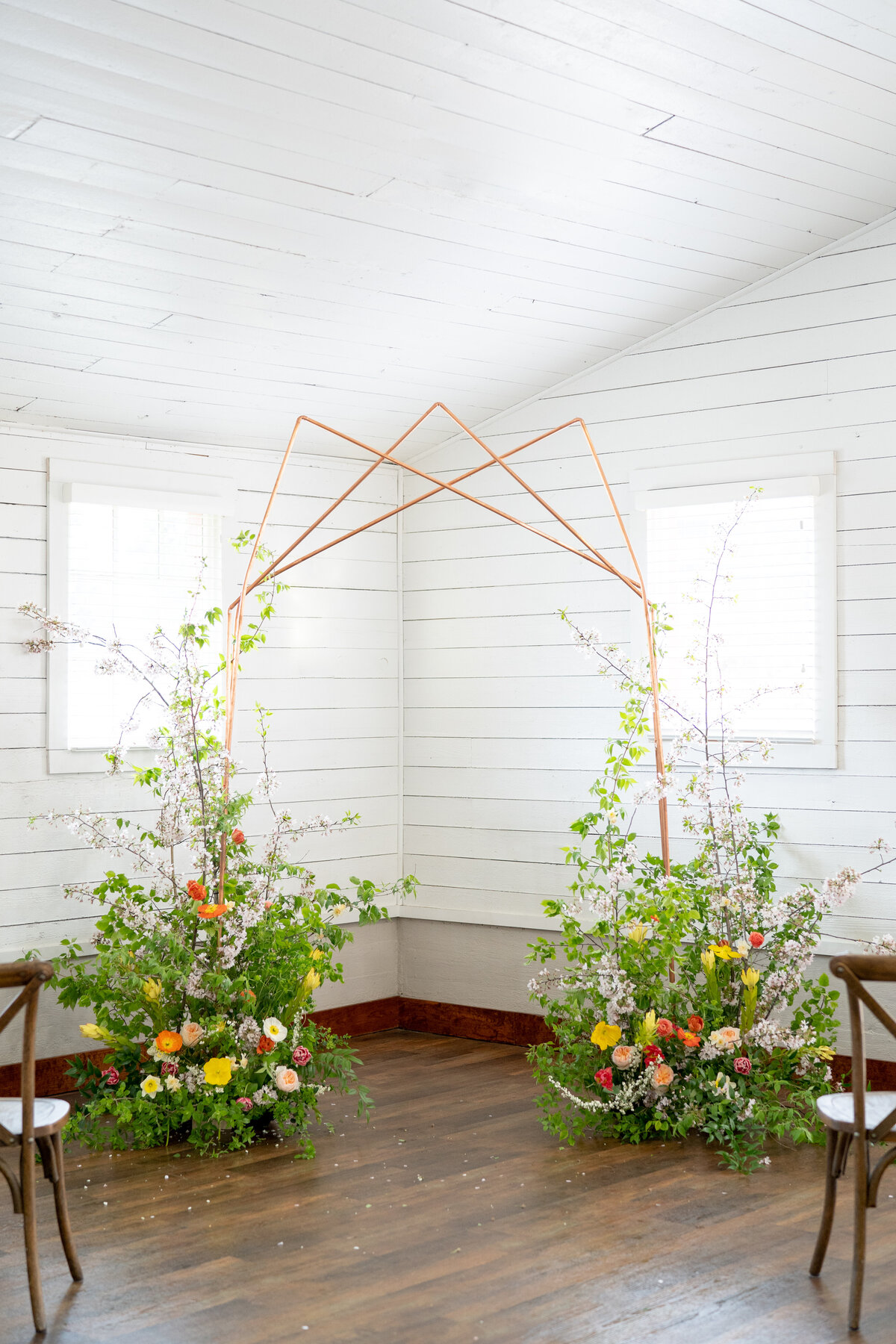 indoor wedding ceremony with spring summer flowers