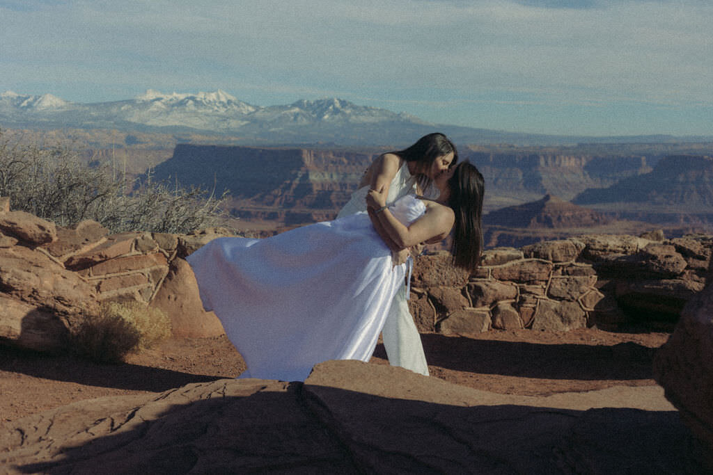 A person dipping their partner while on top of a canyon.