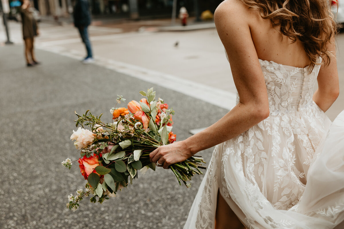 Bride Walking in the street to ceremony with Bridal Bouquet