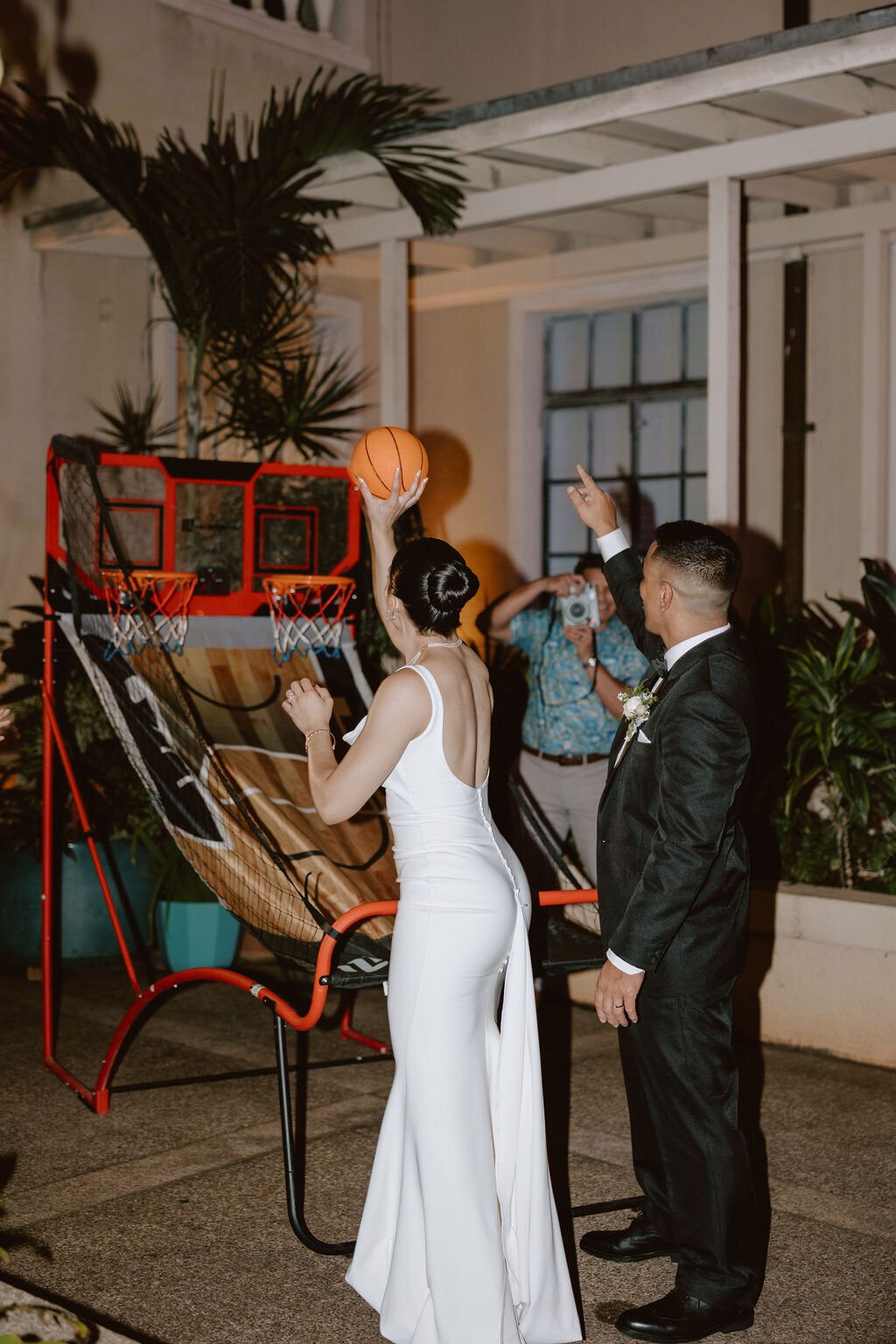 Bride and groom playing basketball at their wedding