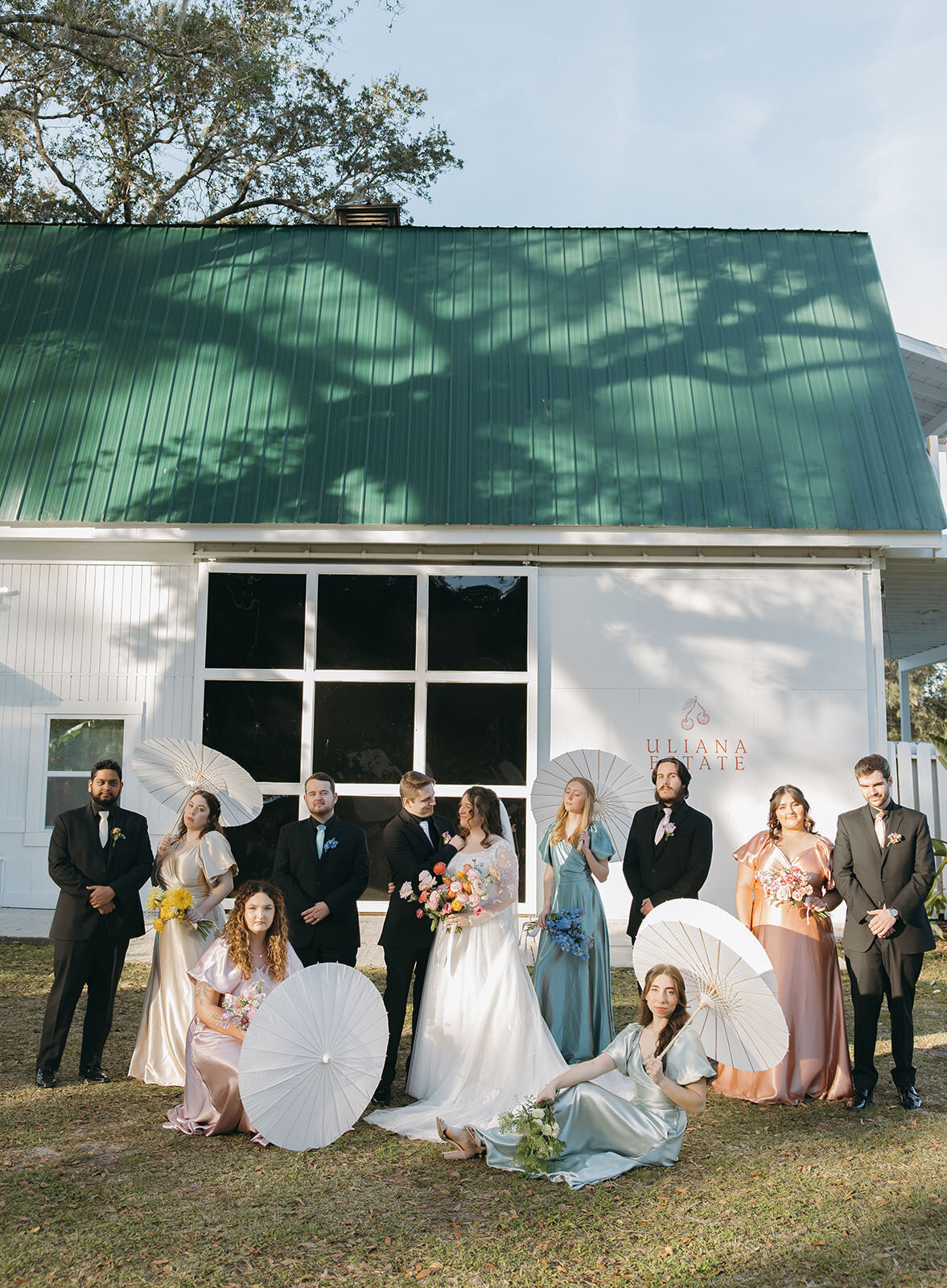 Wedding party posing in front of the white building at Uliana Estate, a romantic Lakeland Florida wedding venue.