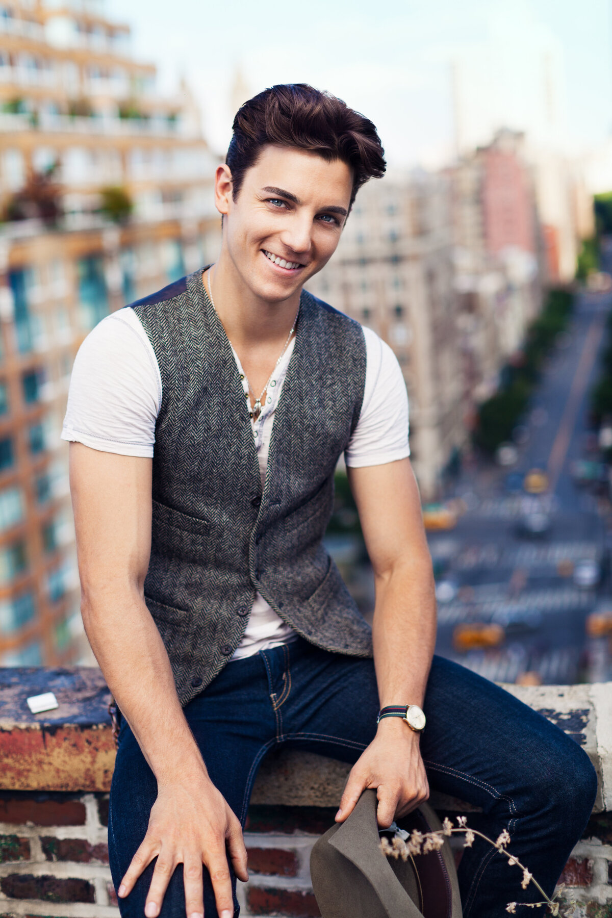 Stylish outdoor portrait of Terrence Ruggiero in a vest and jeans, exuding confidence, captured by Ylva Erevall.