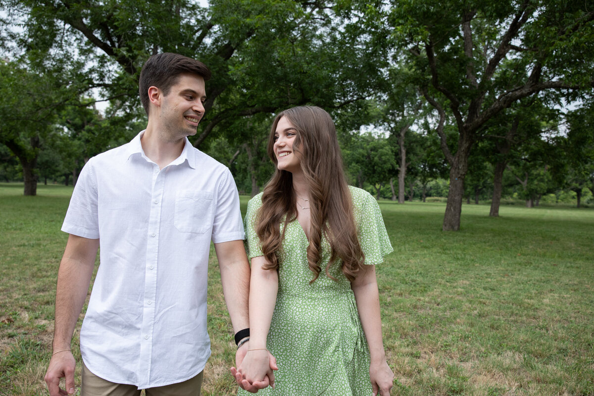 As an Austin wedding photographer, I capture beautiful moments of couples holding hands in a park.