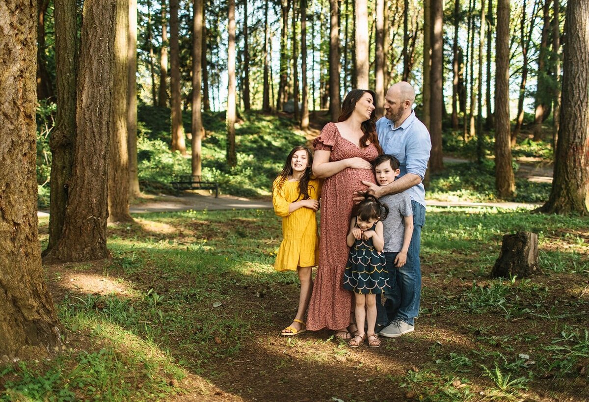A family snuggles together smiling 