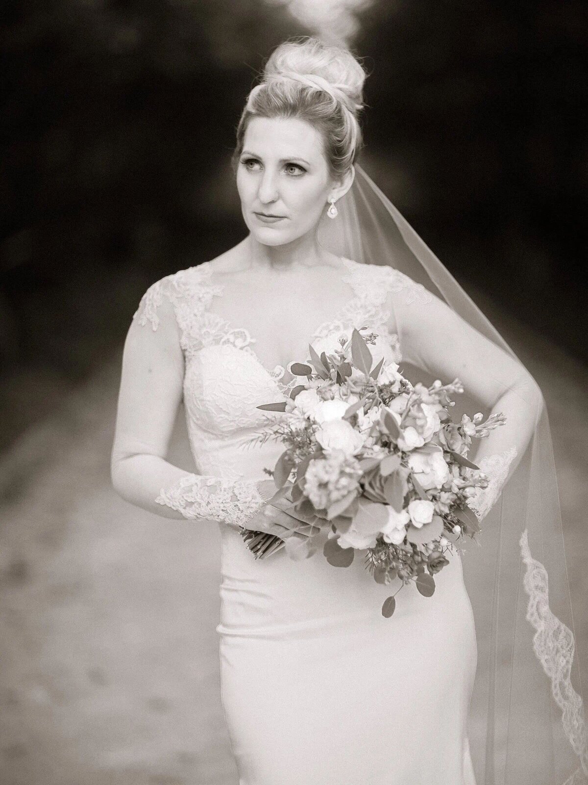 A bride looking off to the side while holding a bouquet of flowers