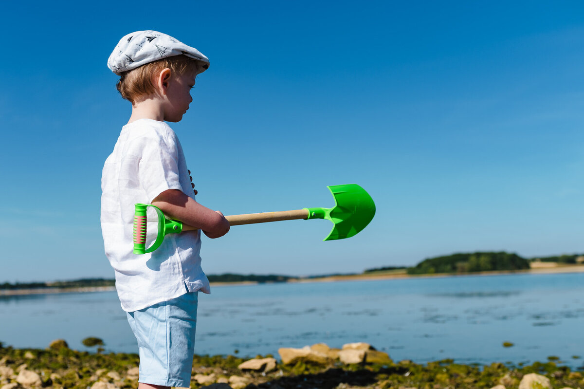 Little boy with spade at rutland water family photoshoot