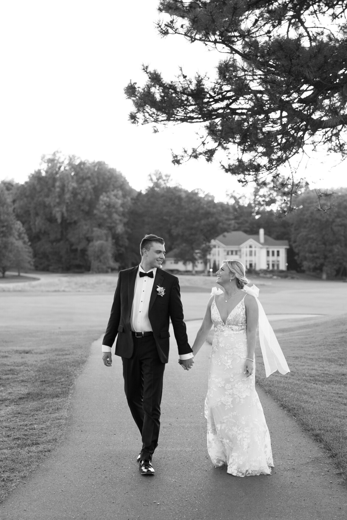 Beautiful portraits of the bride and groom at Bishops Bay Country Club in Madison, showcasing their love against the stunning backdrop of the golf course and lake.