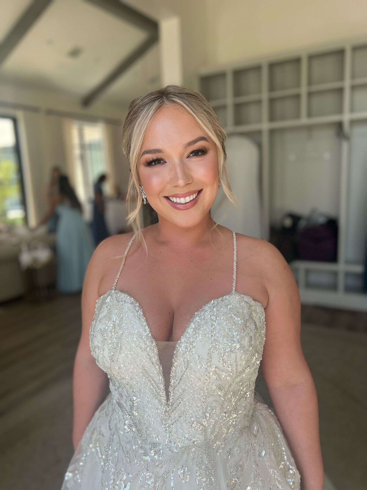 Smiling bride in beaded gown with natural glam, captured after bridal party makeup session by Mistique Makeup in Dallas.