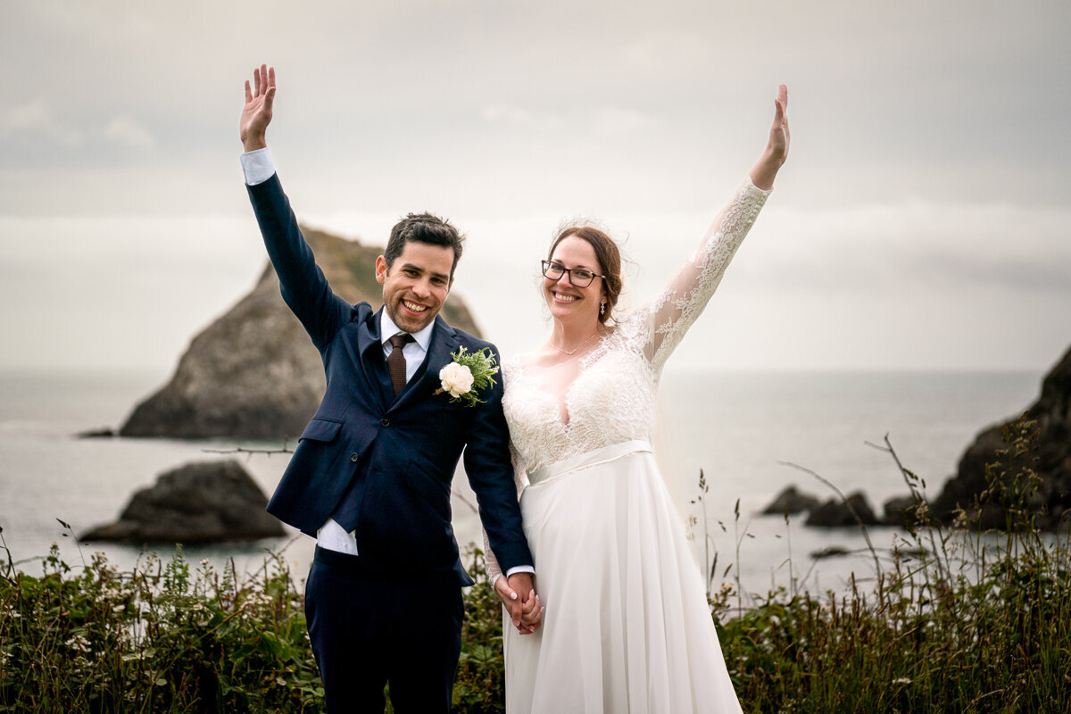A romantic portrait of a bride and groom surrounded by the lush greenery and sweeping ocean views of the Yurok Trail Loop in Klamath.