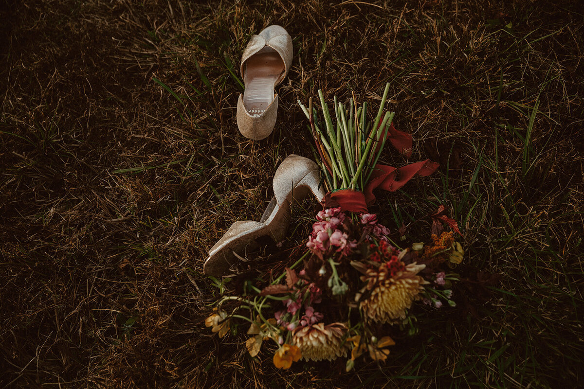 wedding bouquet and shoes on ground