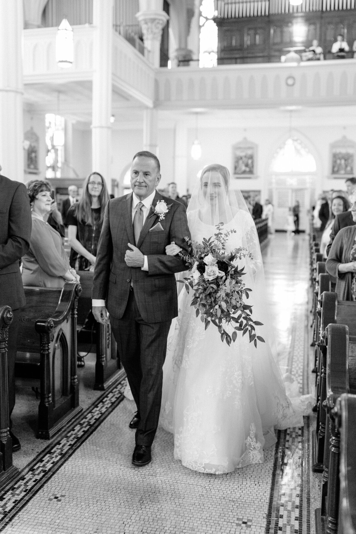 Bride walking down aisle with father for Latin Mass wedding at St. Peter Catholic Church