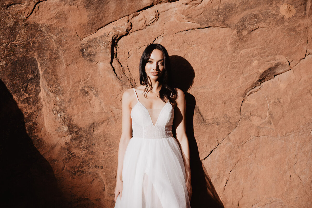 Utah elopement photographer captures woman wearing wedding dress during bridal portraits