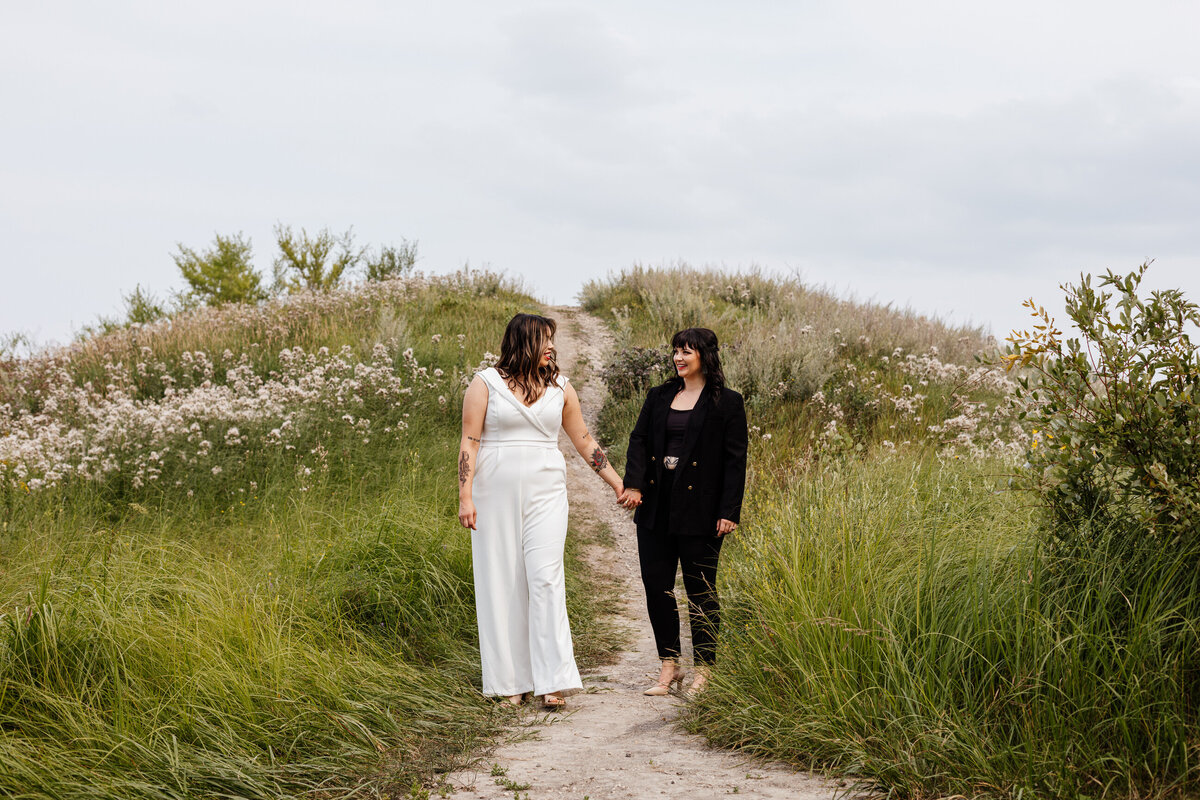Creative portrait of brides on their wedding day at Fort Whyte Alive in summer