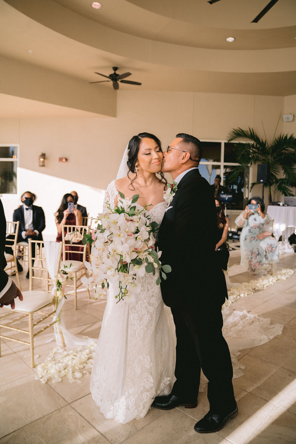 Groom kissing her bride