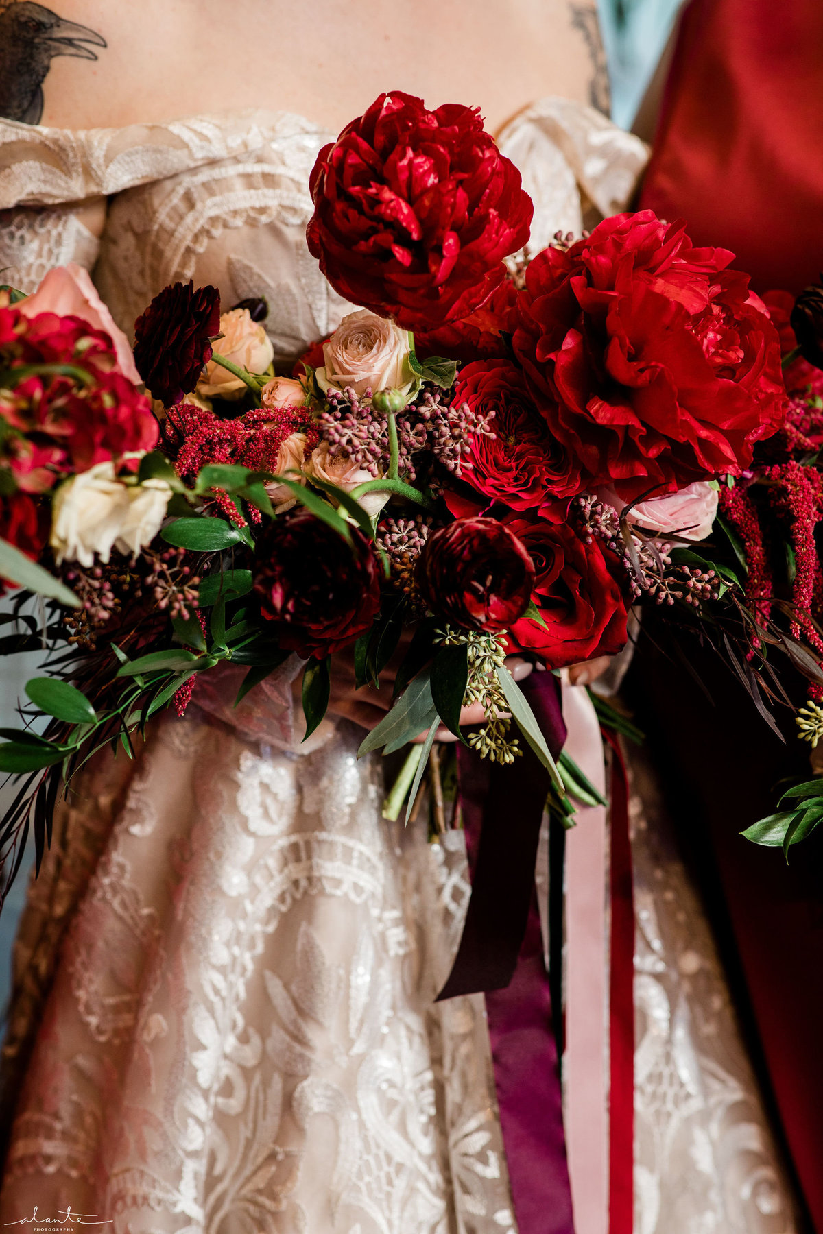 Bride holding all red winter bridal bouquet