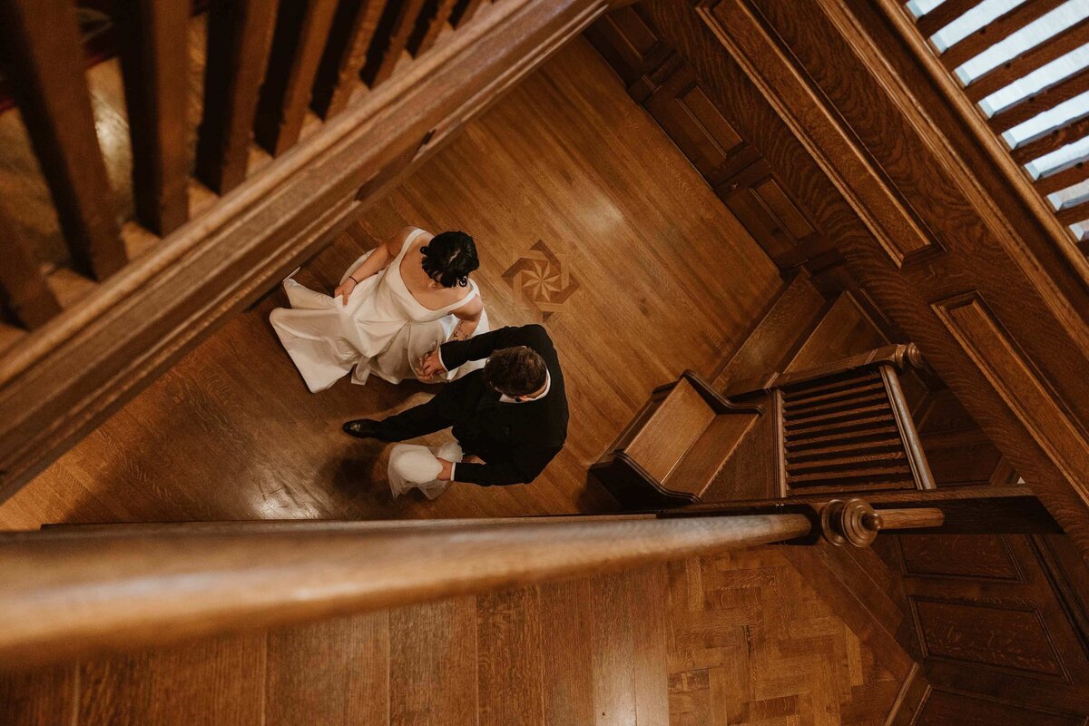Bride and Groom Walking Down Wooden Staircase