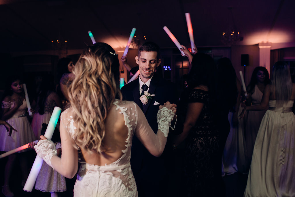 Wedding Photograph Of Visitors, Bride And Groom Raising Their Light Sticks While Dancing Los Angeles