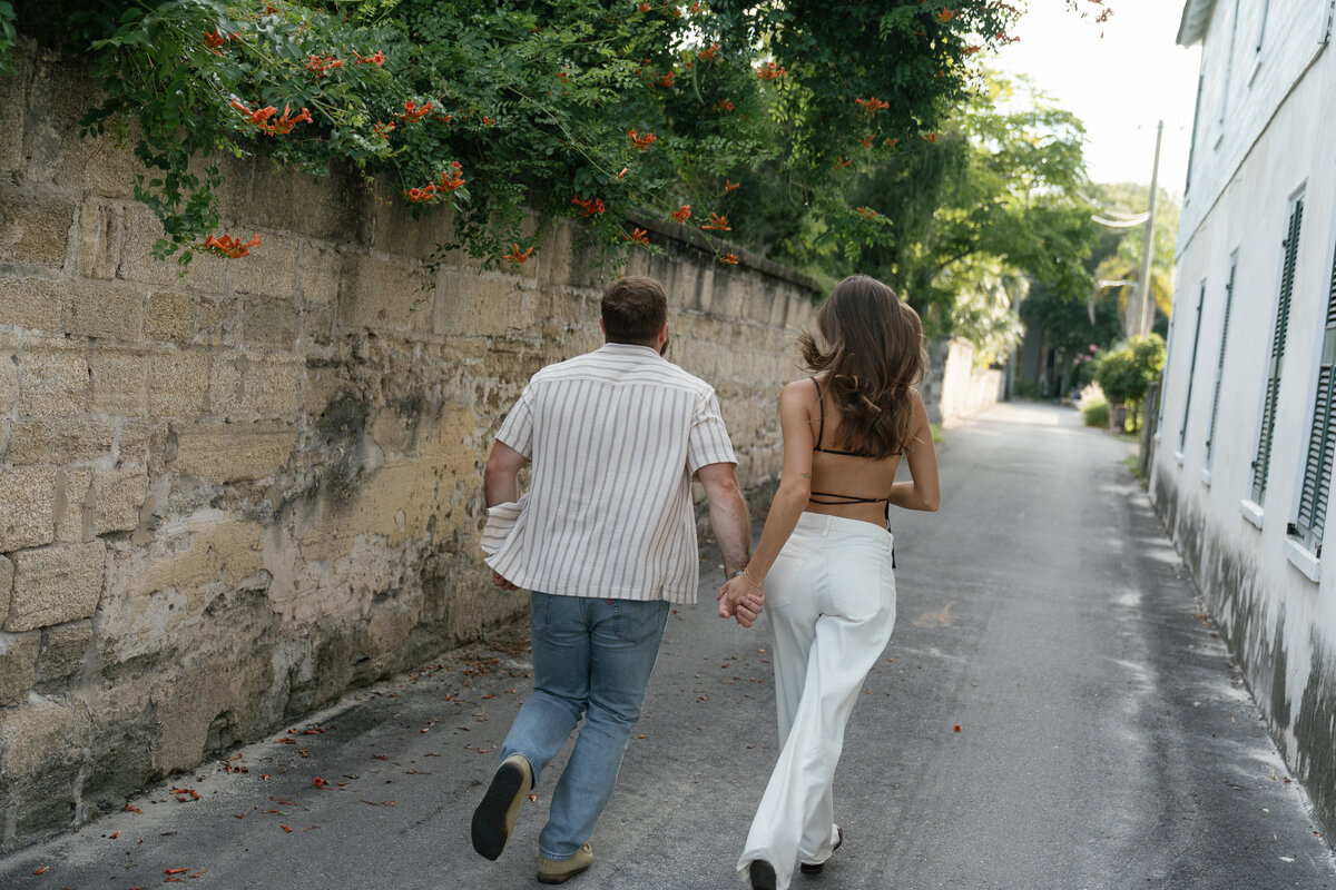 Couple running while holding hands captured by east coast photographer Shelby Ann Photos