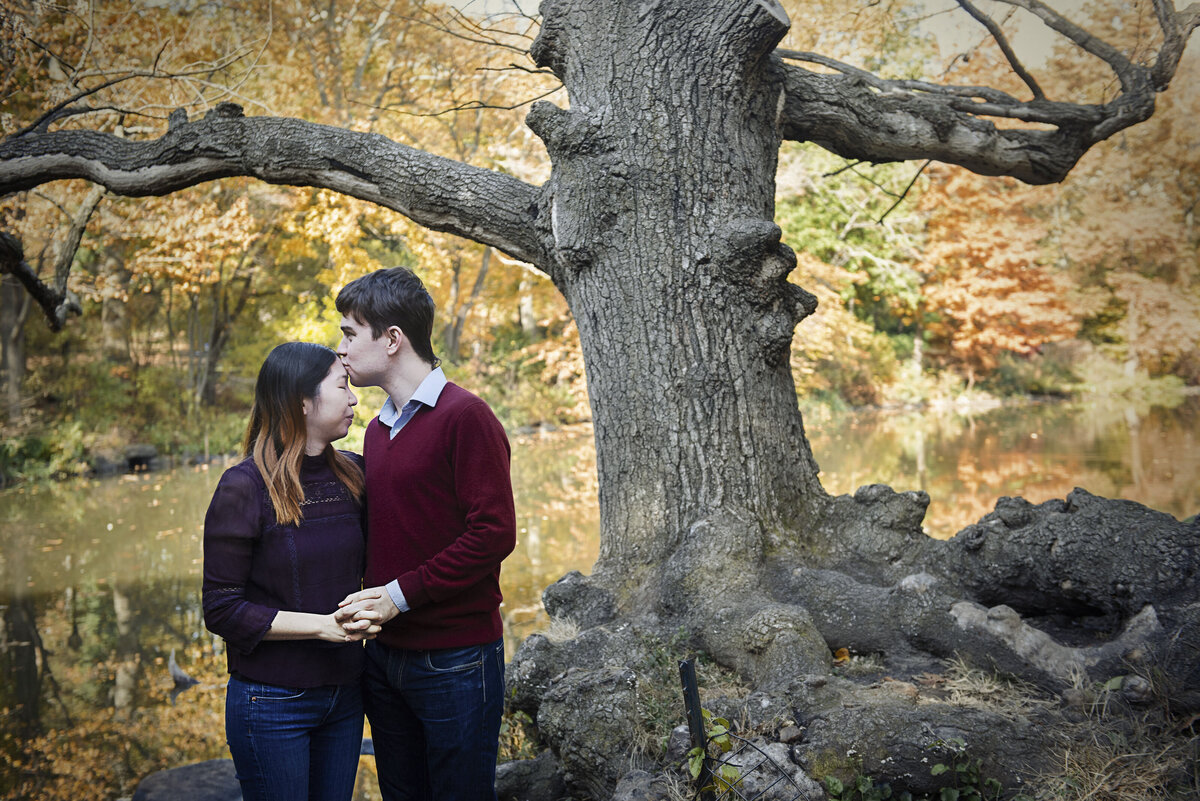 A person kissing their partner's head.