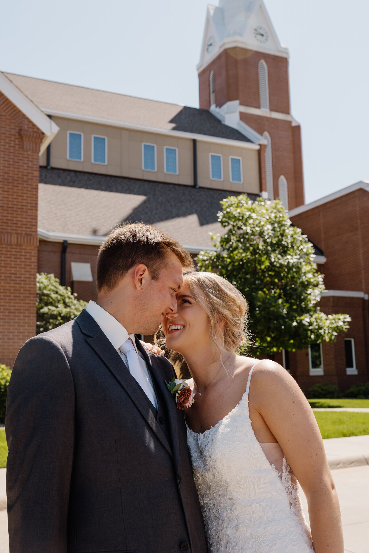 A newlywed couple leaning in for a kiss
