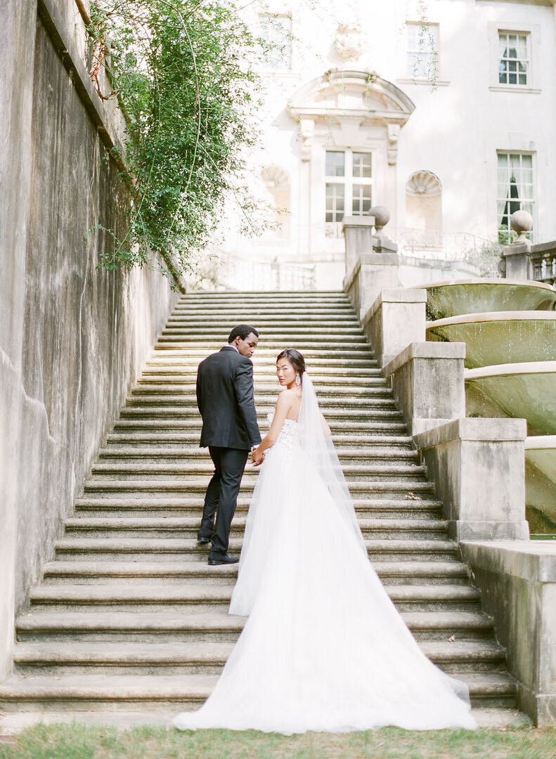 Bride and Groom Walking Up Stairs at The Swan House Photo