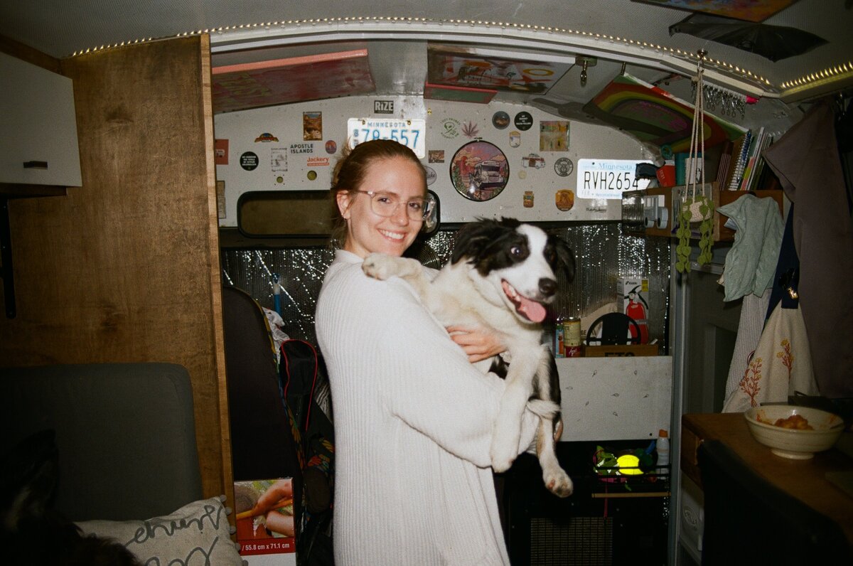 caitlyn and rocky smiling inside of a converted bus