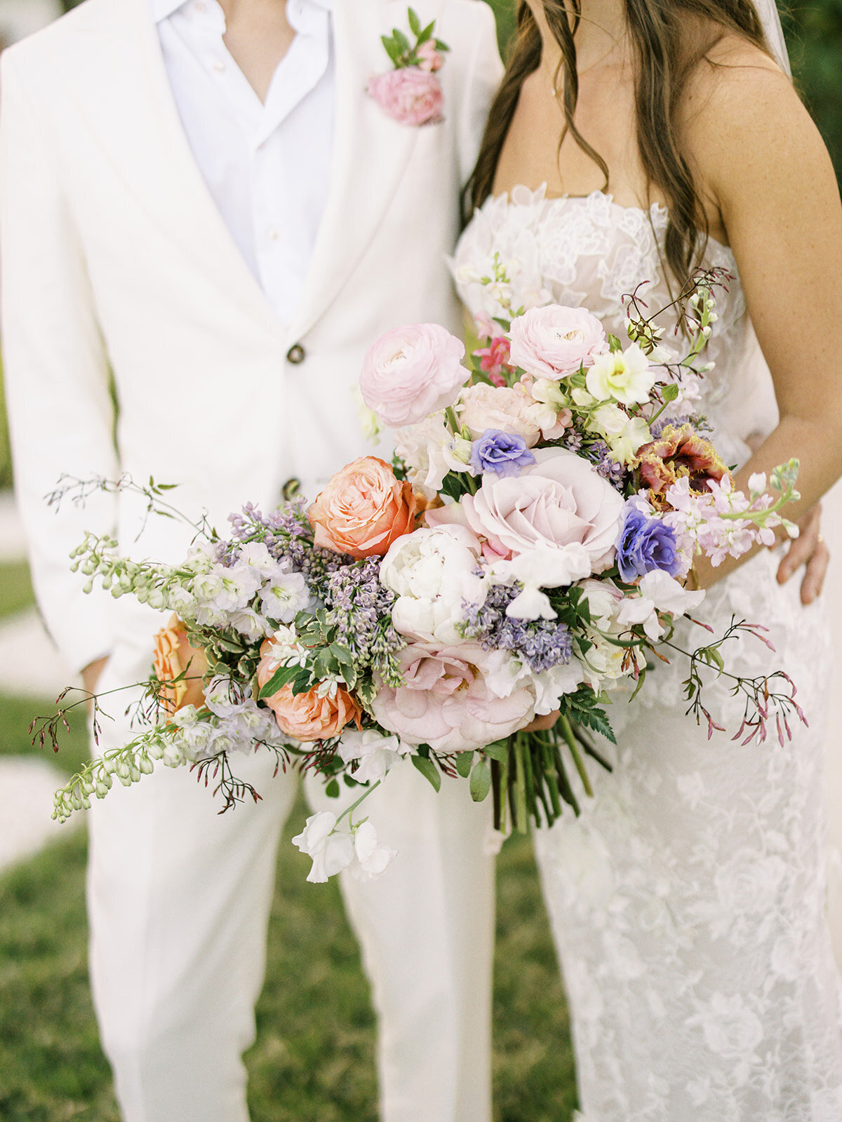 Lush floral heavy bridal bouquet for tropical destination wedding in Exuma, Bahamas. Bouquet in colors of peach, lavender, blush, cream, orange, and pale yellow. Private estate beach wedding. Destination floral design by Rosemary & Finch Floral Design.