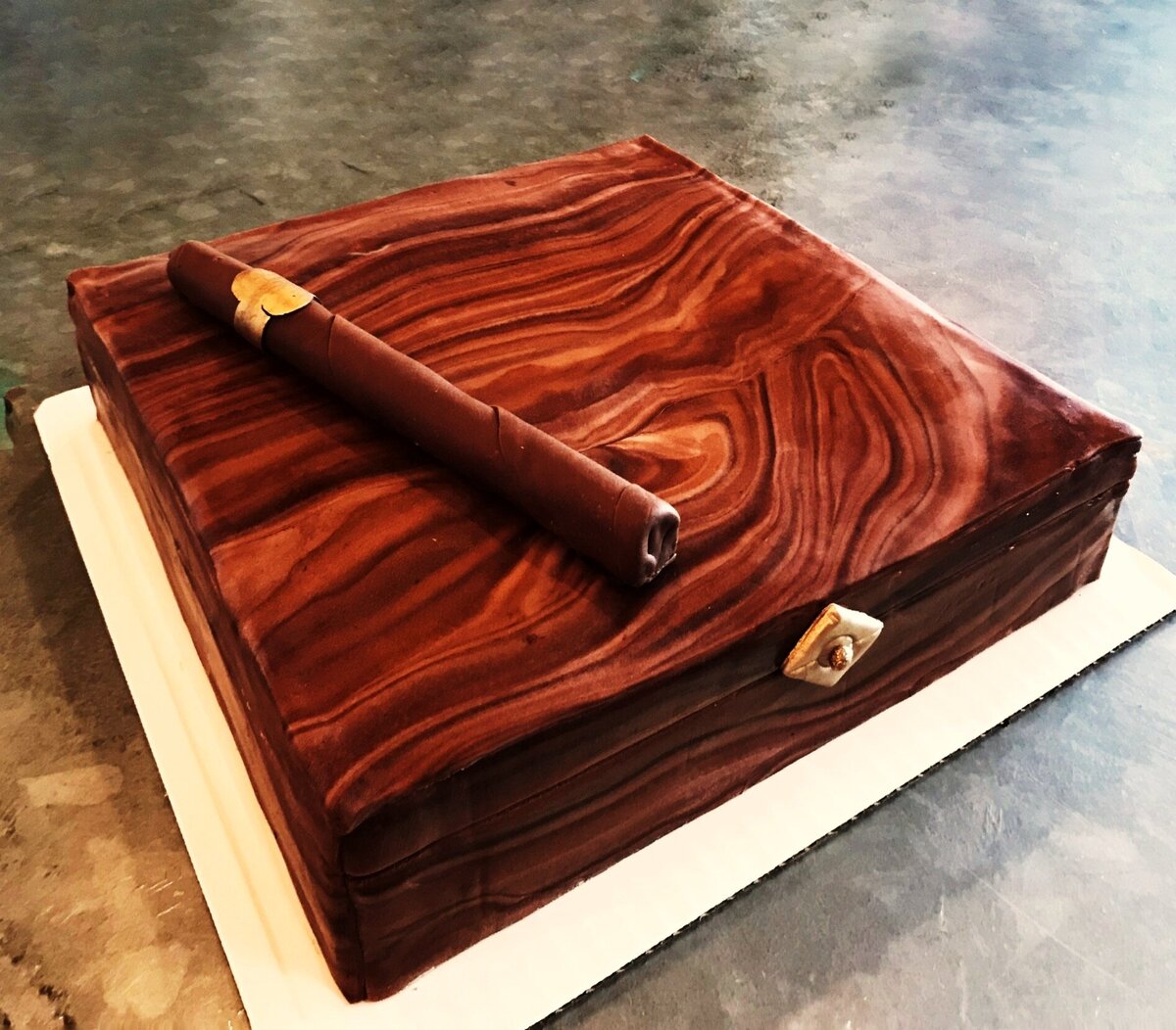 Woodgrain square cigar box cake with rolled fondant cigar on top