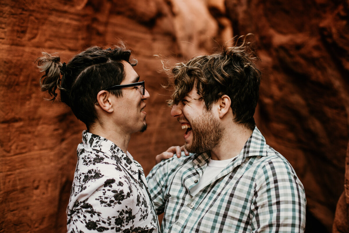 gay couple laughing together in canyon