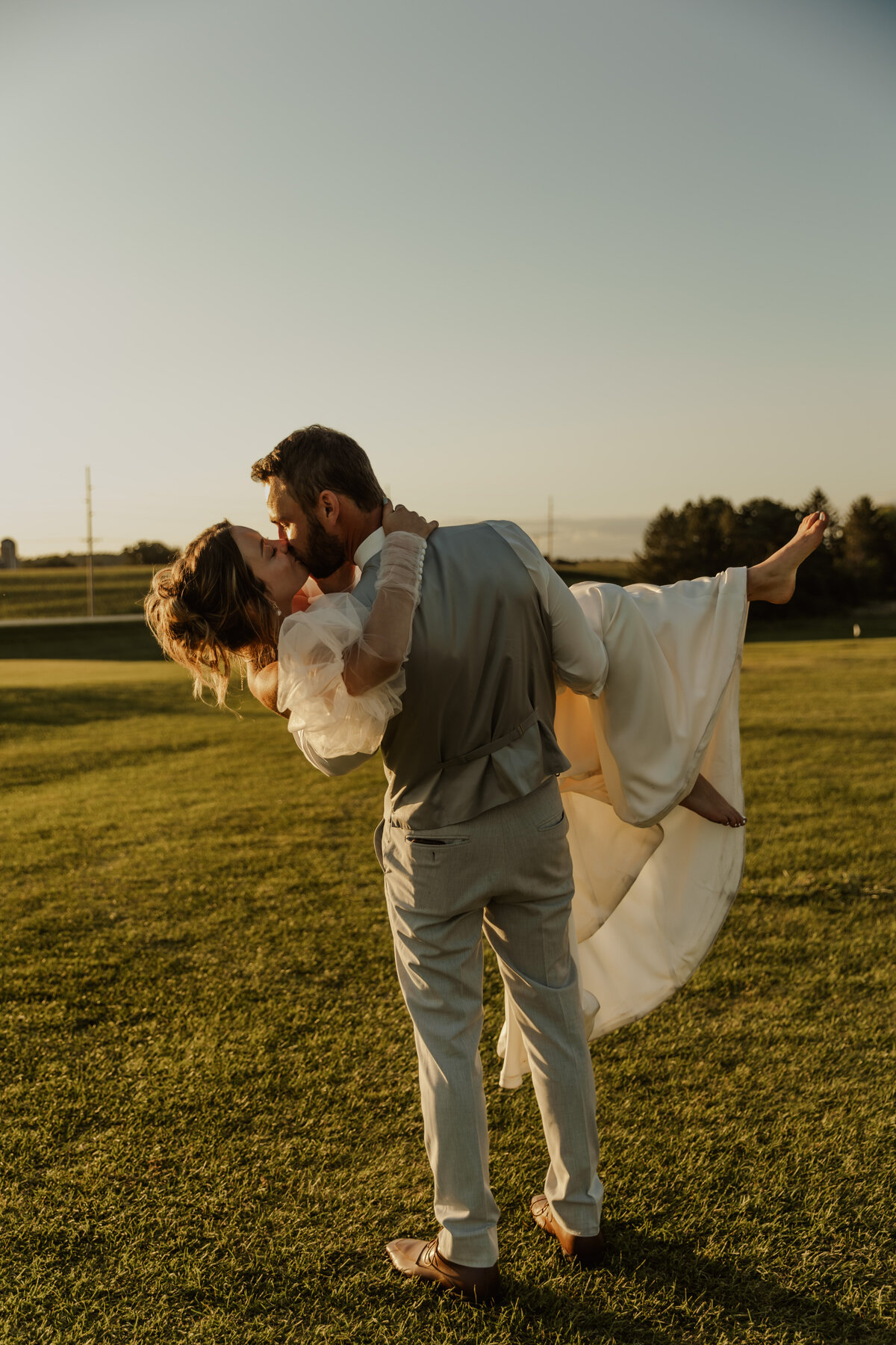 Groom Holding Bride and Spinning at Golden Hour in Caledonia, MN 