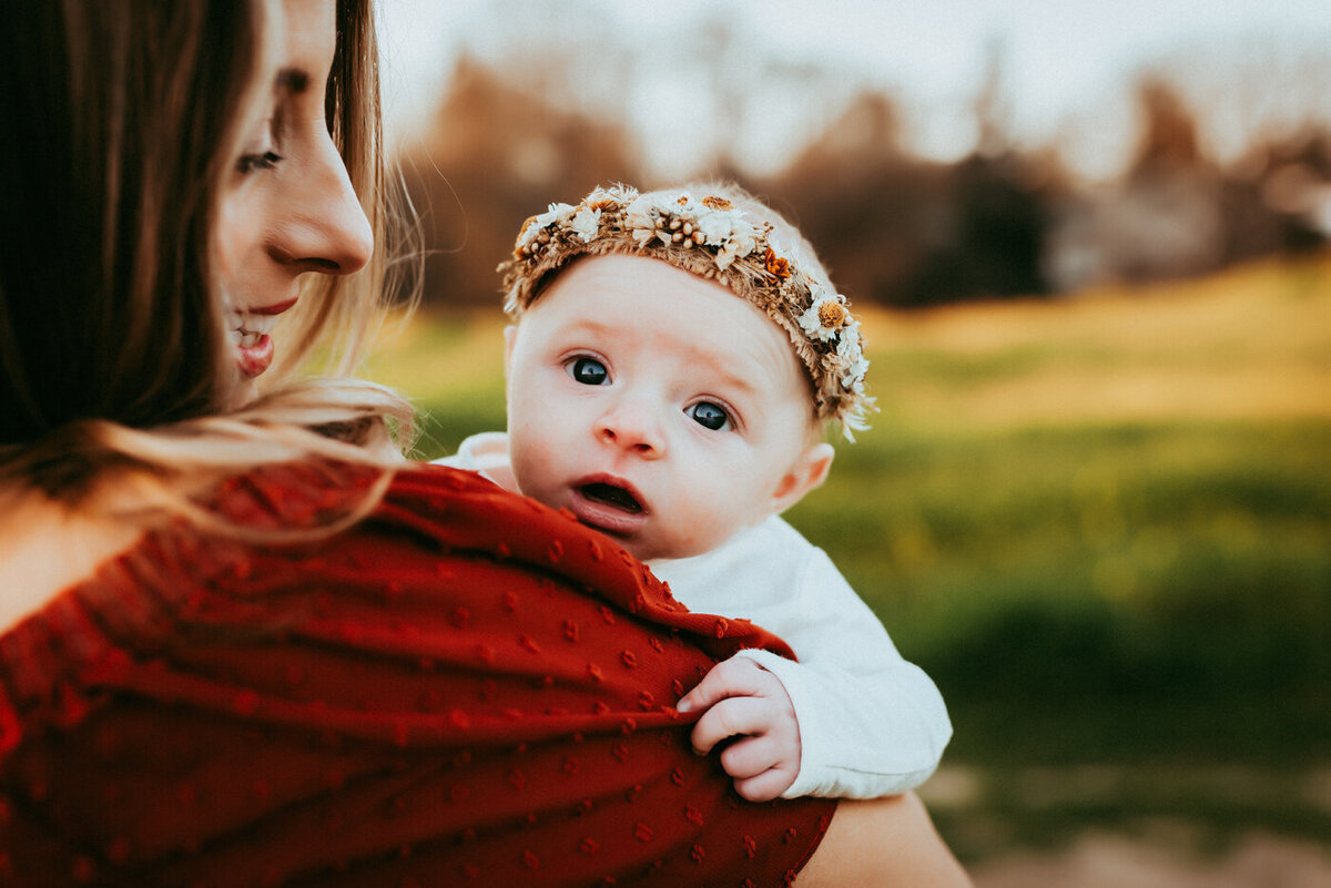 Newborn baby girl wearing flower crown in Martinez outdoor location