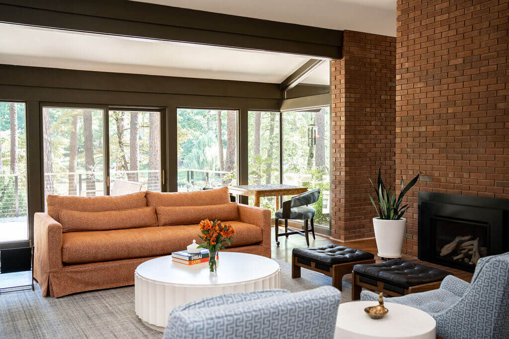sweet southern home mid mod brick fireplace orange couch