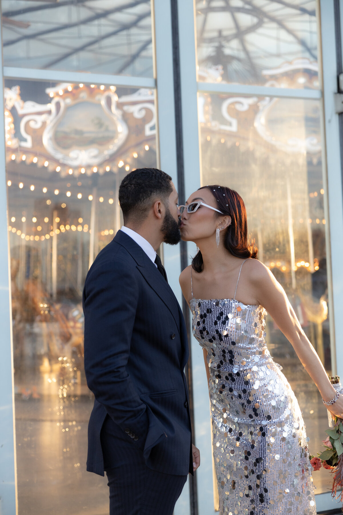 A stylized editorial shot of the couple with the Brooklyn Bridge as the dramatic backdrop in Brooklyn.