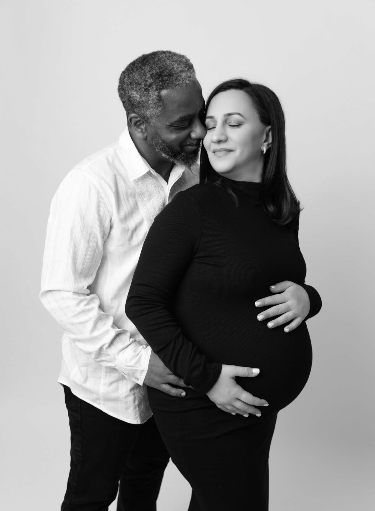Modern NYC maternity photography parents to be smiling at each other during pregnancy photoshoot in Brooklyn 