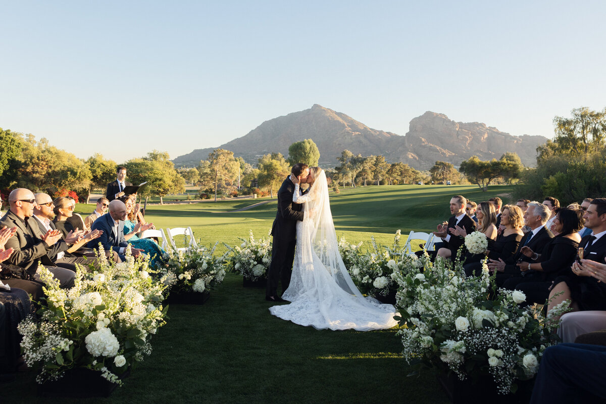 Bride and groom share first kiss at wedding ceremony