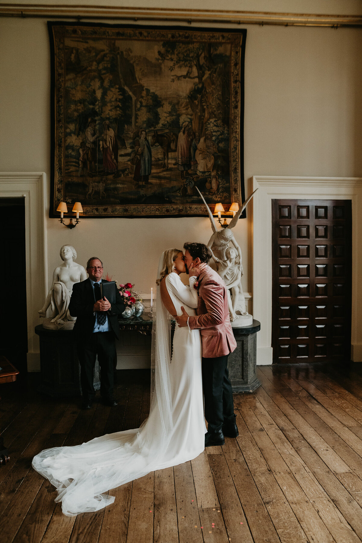 A couple kiss for the first time during their wedding ceremony at Elmore Court.
