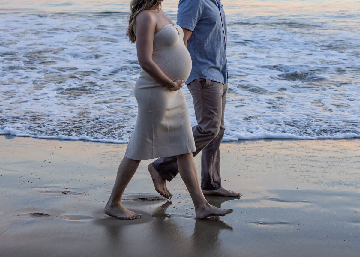 walking couple on the beach maternity photo