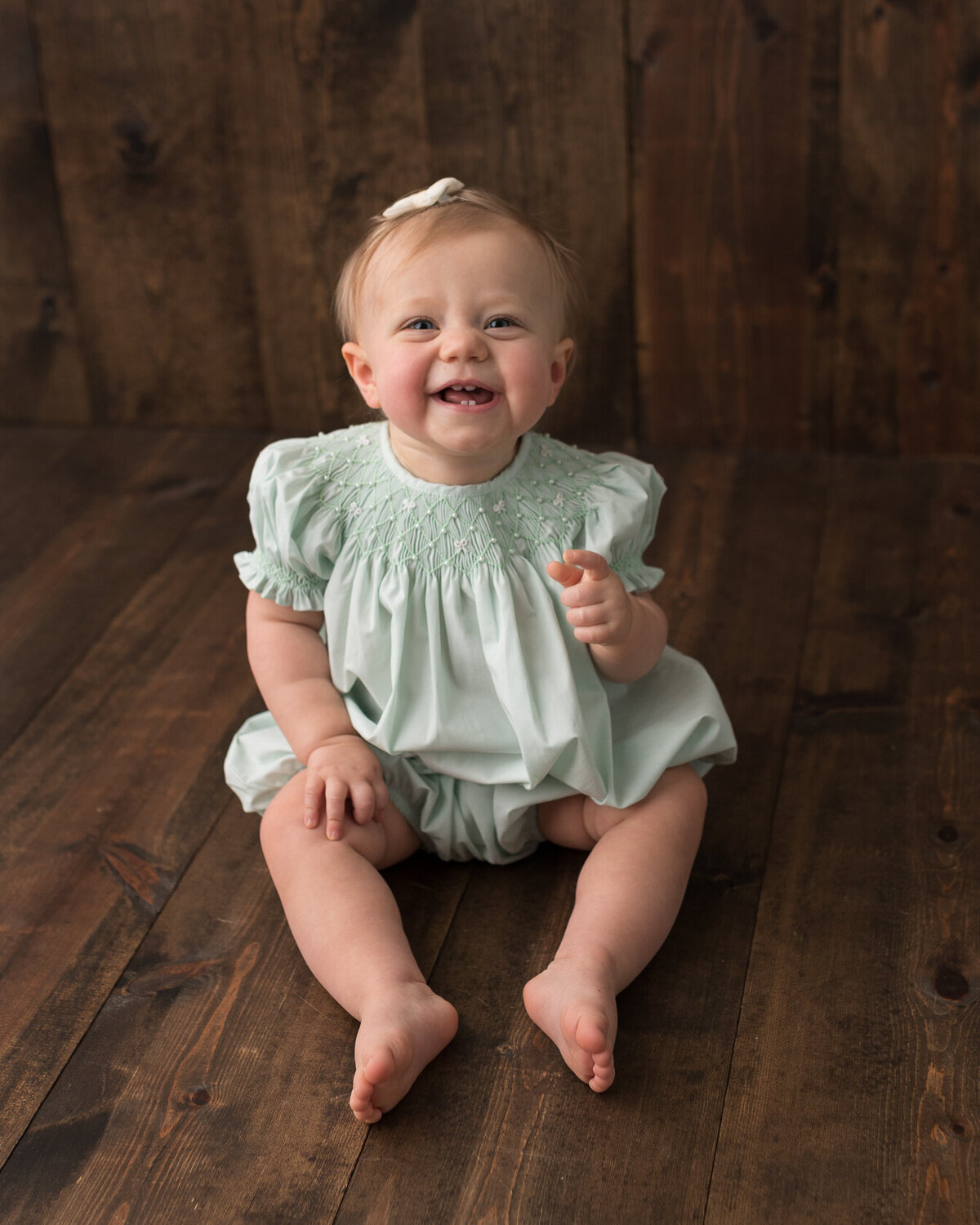 Sitting baby in green dress portrait by Laura King, Houston Photographer